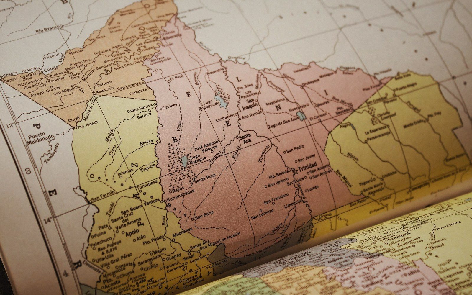 Close-up of an atlas page showing regional borders, towns and rivers in Bolivia